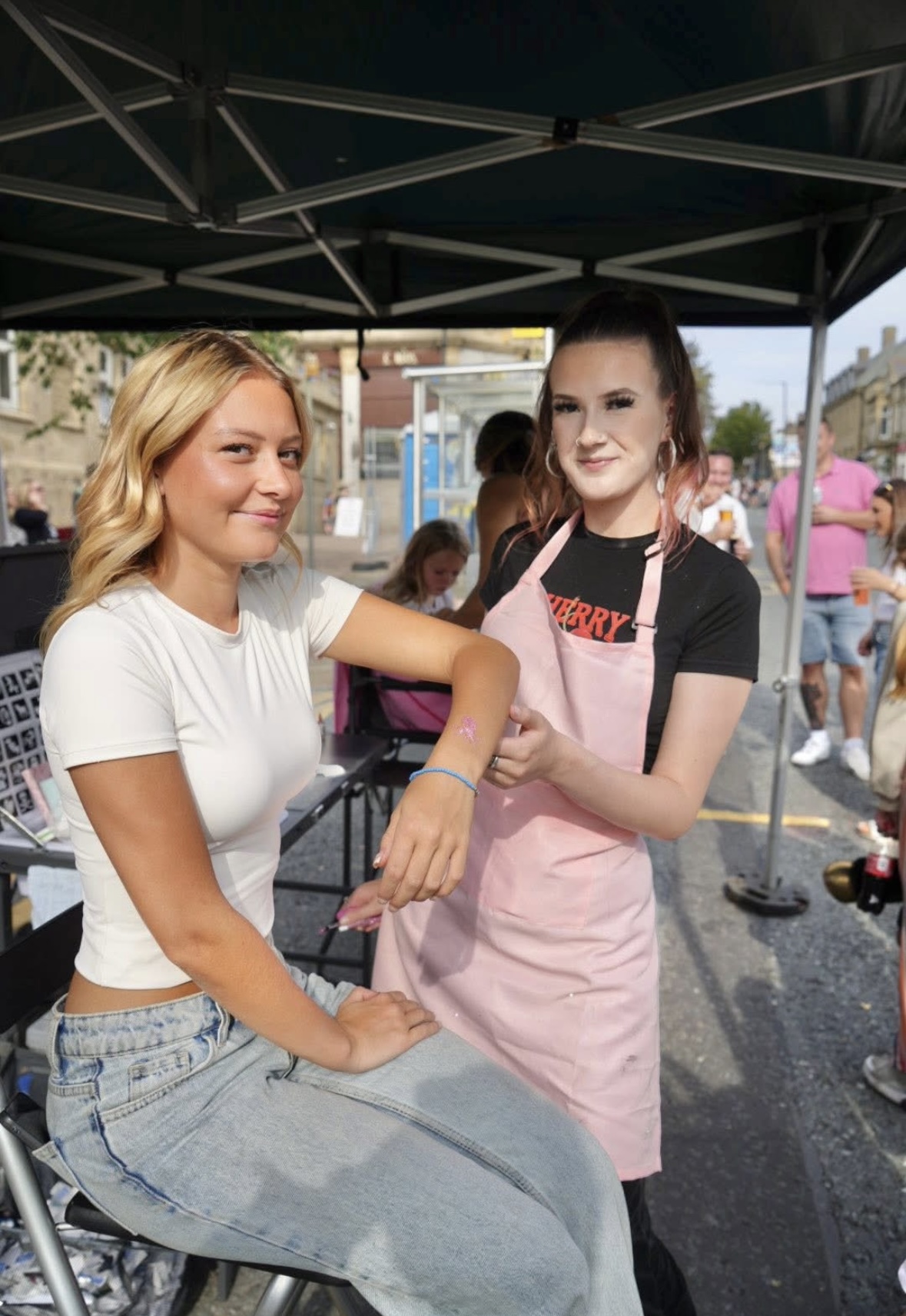 Dream Station glitter artist applying a glitter tattoo at an event